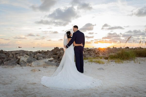 Bride and groom at sunset on Clearwater Beach outside the Opal Sands Resort