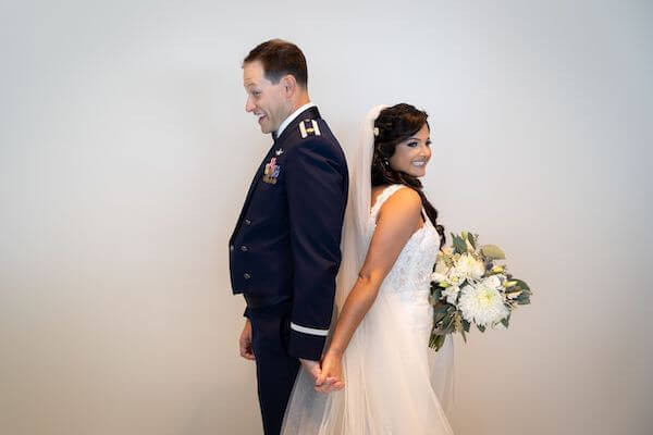 Bride and groom touching but not looking at each other