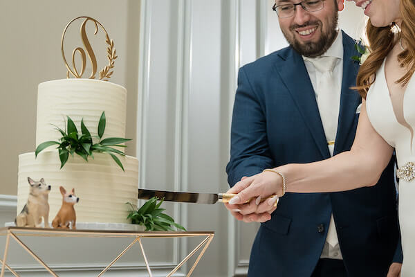 bride and groom cutting their two-tiered intimate wedding at their reception at The Birchwood