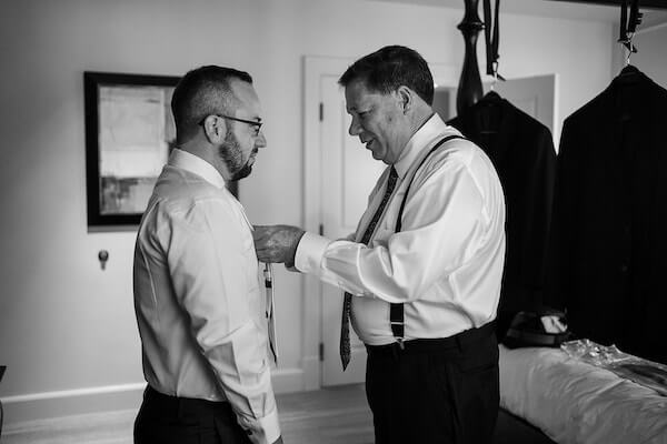 Groom getting dressed on his wedding day