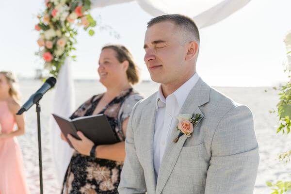 A tear rolls down the groom's face as he sees his bride for the first time