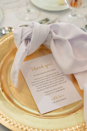 Gold charger plates with a personalized thank you note from the bride and groom