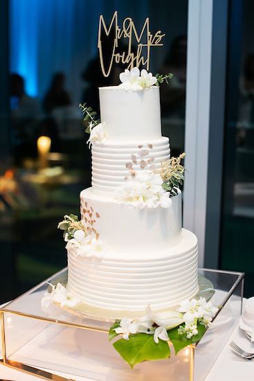 Four-tiered white wedding cake.