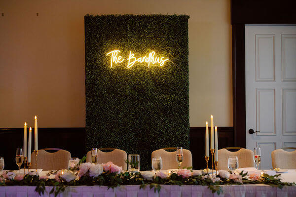 Headtable and neon sign backdrop for a Sandpearl Resort wedding