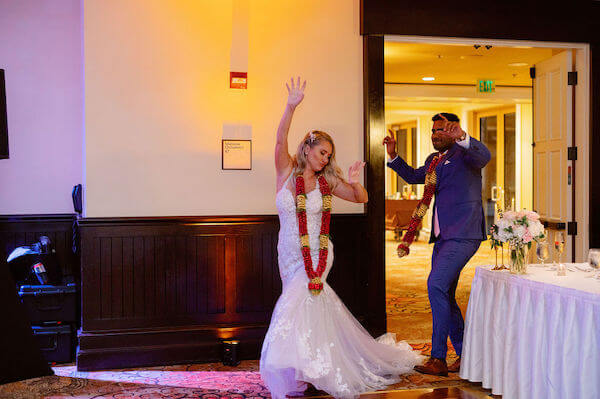 Bride and groom are a grand entrance at their Sandpearl Resort wedding