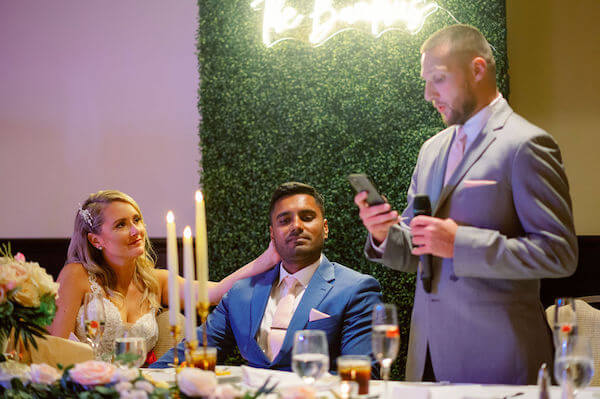 Best man making a toast at an intimate Sandpearl Resort wedding reception