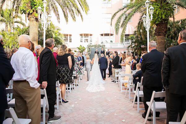 Bride walking down the aisle for her St. Pete Beach wedding at the Don Cesar.