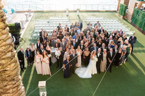Group wedding photo on the event lawn at the Opal Sands Resort