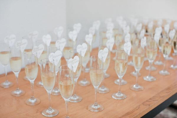 Champagne glasses with heart-shaped escort cards