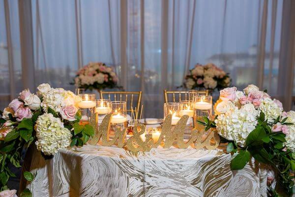 Blush, white and gold sweetheart table at an Opal Sands wedding reception