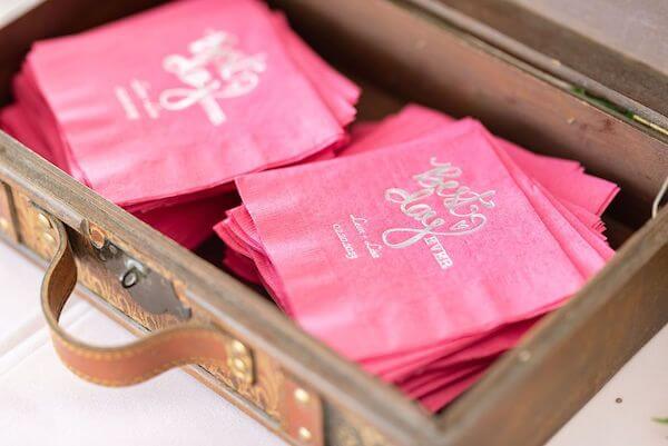 Custom fuchsia colored napkins for a travel-themed wedding reception