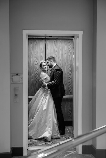 A bride and groom in an elevator after their downtown Tampa wedding.