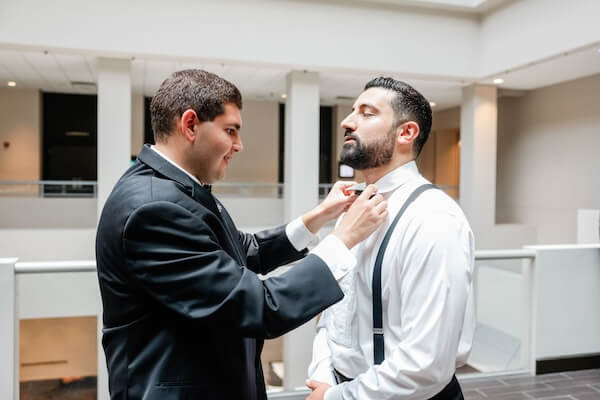 best man fixing the groom's tie for his downtown Tampa wedding