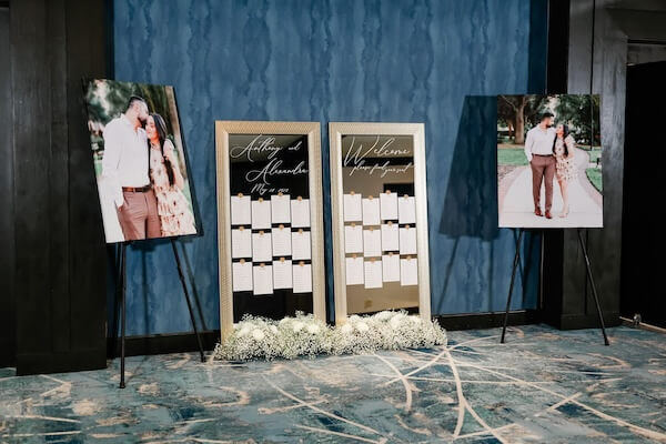 Mirrored seating chart flanked by portraits of the bride and groom for a downtown Tampa wedding