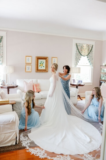 Tampa Bay bride getting dressed with the help of her bridal party