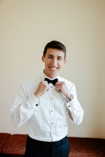 Groom fixing his bow tie