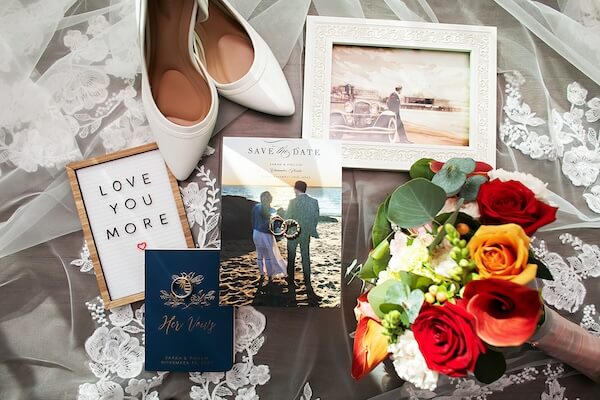 Photo of a couple's wedding day accessories and invitation.