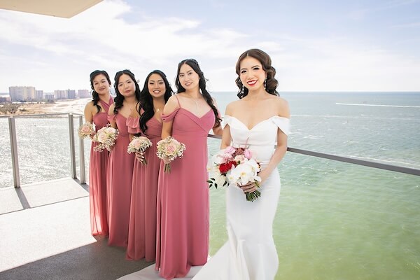 Bride and her bridesmaids on the terrace of the Opal Sands Resort on Clearwater Beach.