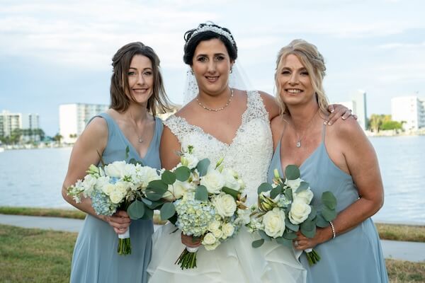 Bride with two bridesmaids in blue. Perfect for a beach themed wedding