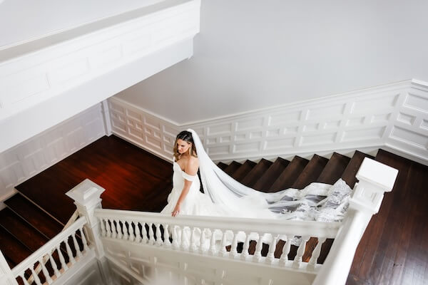 Bride waking down the stairs at the Belleview Inn.