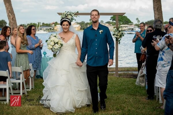 Just Married! Newlywed couple walking back up the aisle.