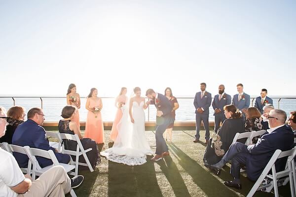 Groom breaking a glass at the end of his Opal Sands wedding ceremony.