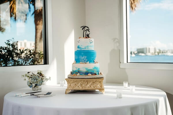 Beach-themed wedding cake and custom topper