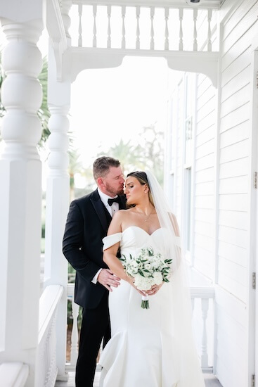 Bride and groom on the verandah of the Belleview Inn.