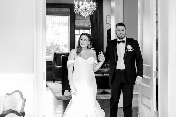 Bride and groom taking a sneak peek at their reception in the Tiffany Room of the Belleview Inn.