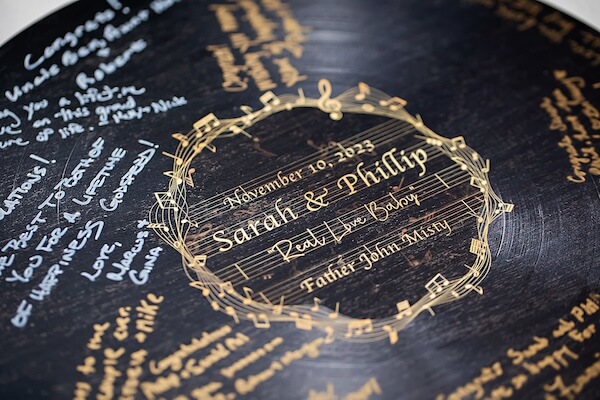 Guests wrote wishes for the newlyweds on a vinyl record.