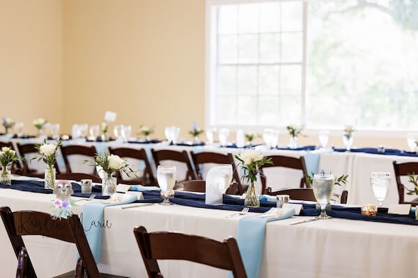Tables dressed in blue, whuite and silver for an afternoon wedding reception.