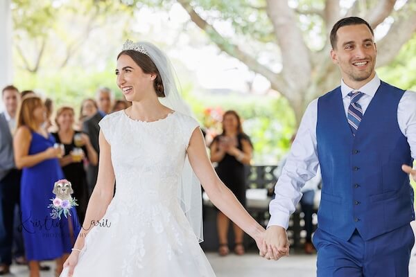 Bride and groom entering their afternoon wedding reception at Davis Islands Garden Club.