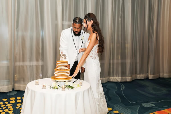 A bride and groom cutting their cookie cake at their Clearwater wedding reception.