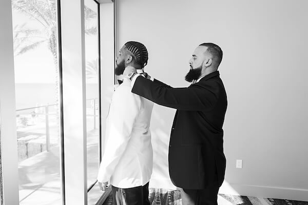 Best man helping the groom get ready.