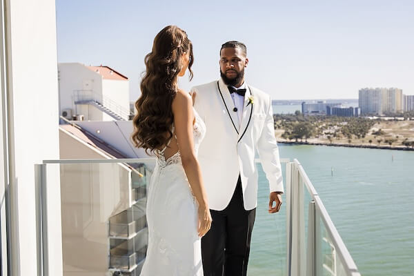 A bride and groom's first look overlooking Clearwater Beach and the Gulf of Mexico at the Opal Sands Resort.