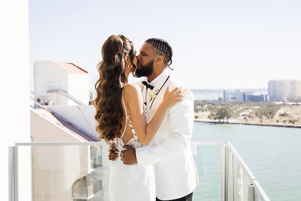 A bride and groom's first look overlooking Clearwater Beach and the Gulf of Mexico at the Opal Sands Resort.