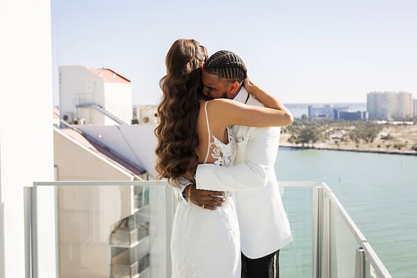 A bride and groom's first look overlooking Clearwater Beach and the Gulf of Mexico at the Opal Sands Resort.