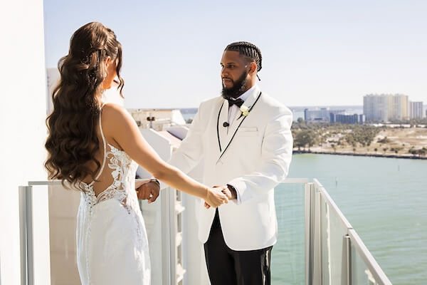 A bride and groom's first look overlooking Clearwater Beach and the Gulf of Mexico at the Opal Sands Resort.