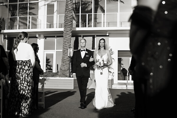Bride and her father walking down the aisle at her Opal Sands wedding ceremony.