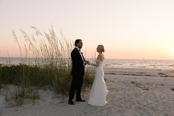 A bride and groom enjoying the sunset on Sand Key.