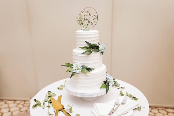 A modern three-tiered white wedding cake.
