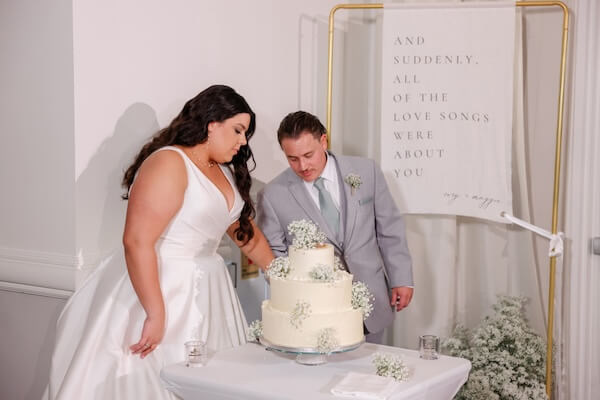 A bride and groom cutting their wedding cake.