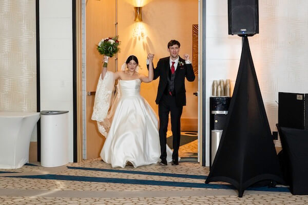 A bride and groom are making their grand entrance.