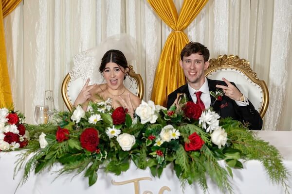 A newlywed couple at the sweetheart table.