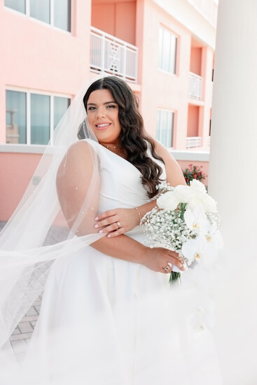 A bride with a white orchid bouquet.