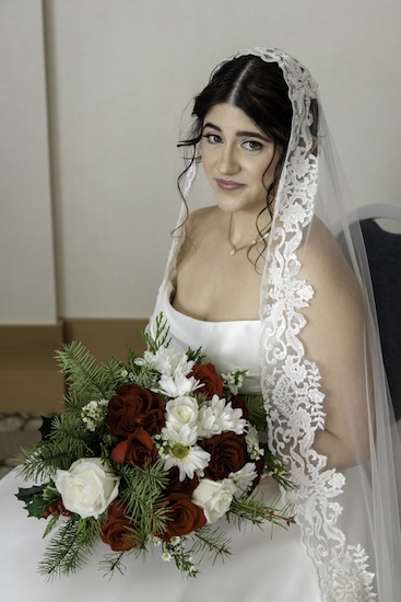 A bride with a white and red holiday bouquet for her Clearwater wedding.