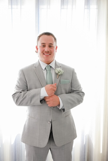 A groom getting ready for his wedding ceremony on the Hyatt Regency Clearwater Beach's Sky Terrace