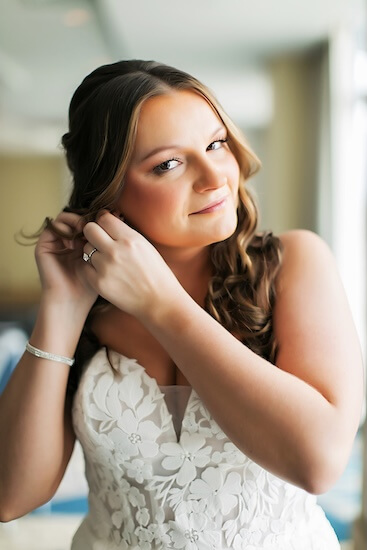 Bride putting on her wedding jewelry at the Wyndham Grand Clearwater Beach.