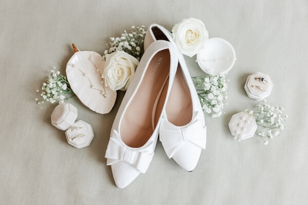 A bride's shoes and wedding accessories