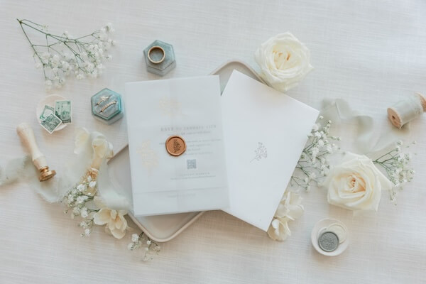 A wedding invitation and wax seals for a Clearwater Beach wedding on the Hyatt's Sky Terrace.